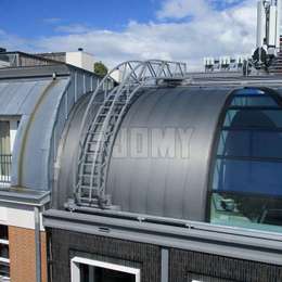 Travelling ladder on roof for window cleaning Travelling roof ladder on rails for building maintenance and window cleaning